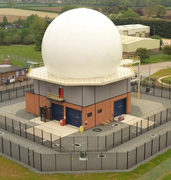 Aerial view of two-layer CPNI base level perimeter security fence installed around an FCDO government radome facility