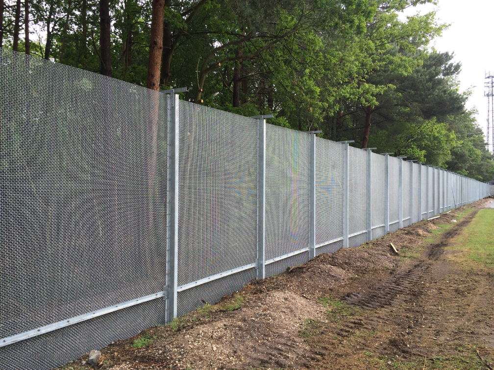 Freshly installed galvanized CANFEN ARMAWEAVE woven mesh security fence panels at a Thames Water treatment works site