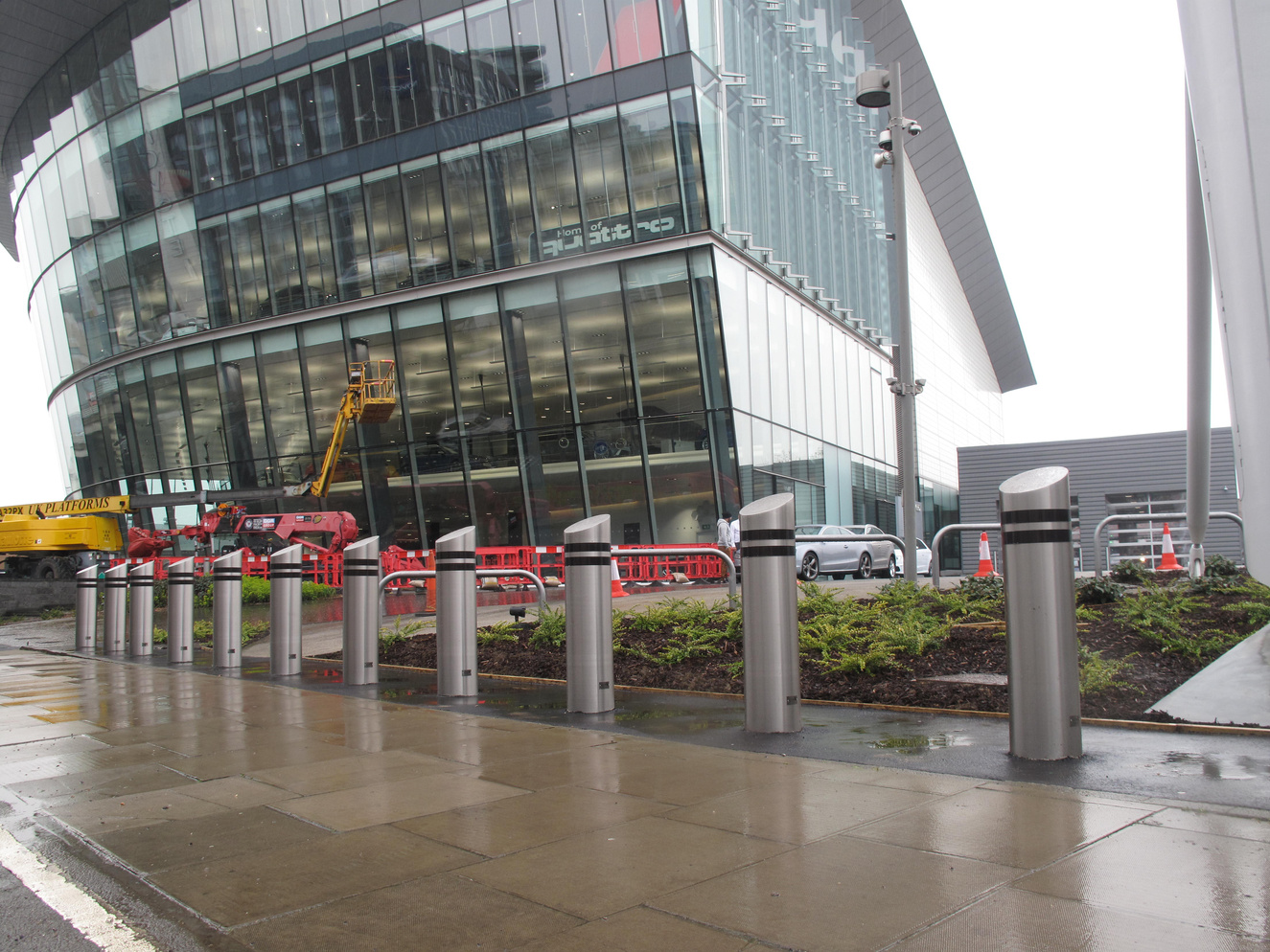 Manufacturer illustration from the Truckstopper 5 datasheet: a row of bollards outside a glazed building