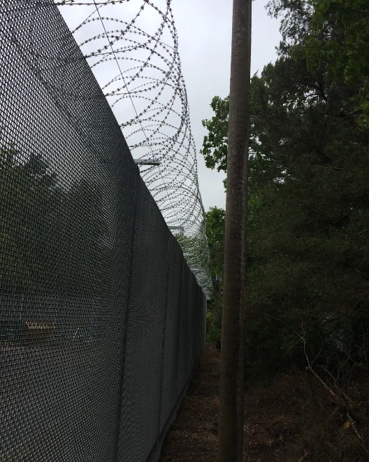CANFEN ARMAWEAVE woven mesh security fence installed along a water treatment works perimeter for Thames Water in the UK