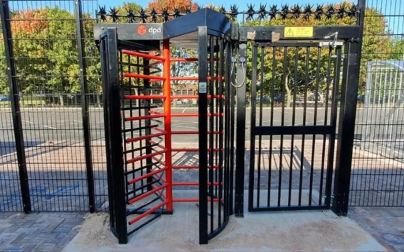 LPS 1175 full-height security turnstile with swing gate installed at a commercial logistics depot perimeter