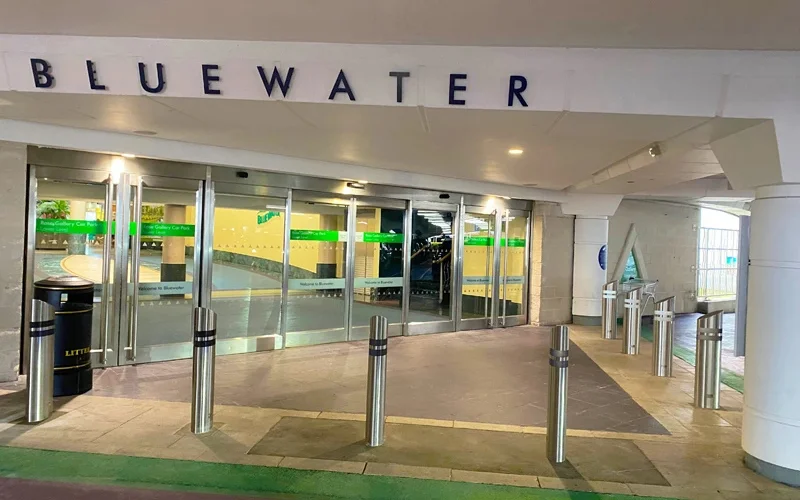 Surface-mount and shallow stainless steel security bollards installed at a UK shopping centre entrance